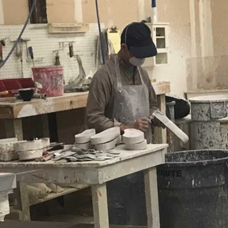 Lab technician working on custom molds for orthotics